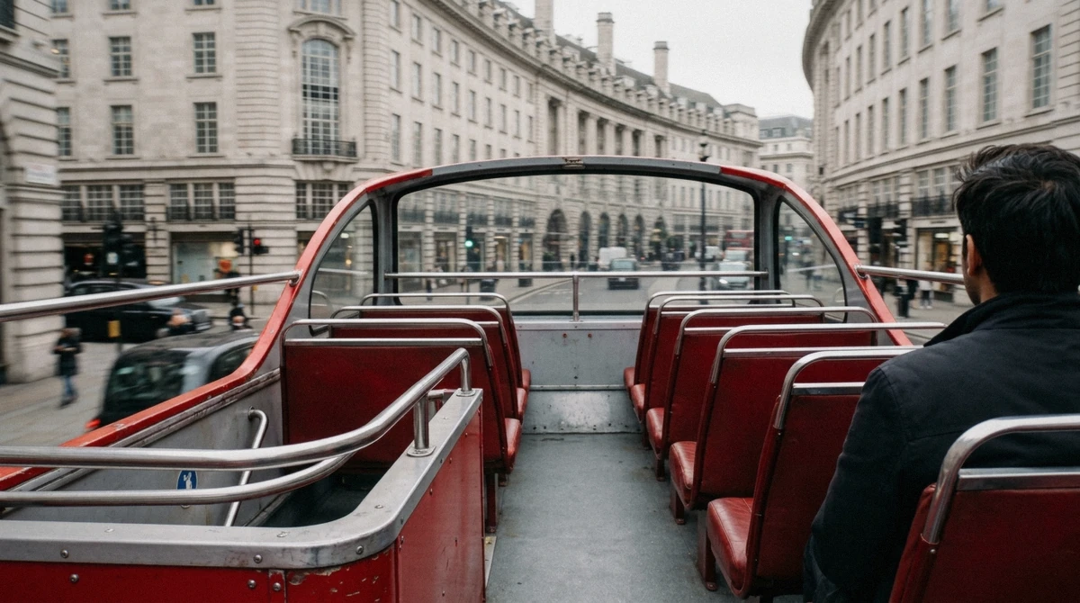 Vintage red open-top double-decker bus on a London open top bus tour passing Big Ben in afternoon sun